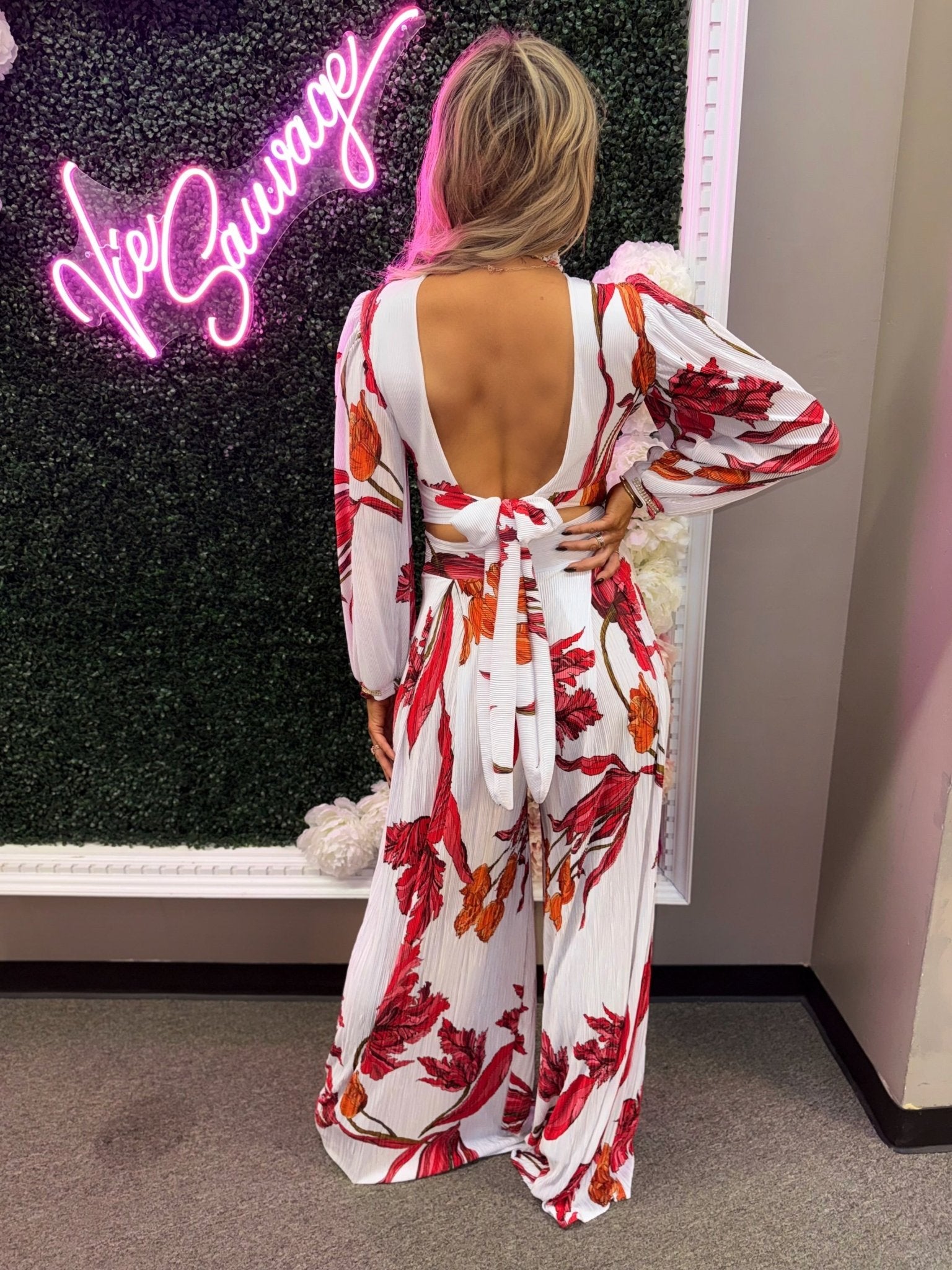 Back view highlighting wrap waist band and cropped fit and sandy pants